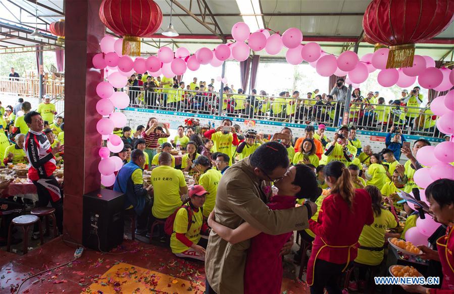 Bridegroom Zeng Di (R, front) and bride Wang Lixia (L, front) kiss during their wedding in Changqiu village of Pujiang county in Chengdu, capital of southwest China's Sichuan Province, April 9, 2016.