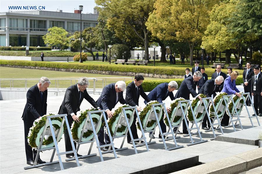 (From L to R) France's Foreign Minister Jean-Marc Ayrault, Italy's Foreign Minister Paolo Gentiloni, Germany's Foreign Minister Frank-Walter Steinmeier, Japan's Foreign Minister Fumio Kishida, U.S. Secretary of State John Kerry, Britain's Foreign Secretary Philip Hammond, Canada's Foreign Minister Stephane Dion and E.U. High Representative for Foreign Affairs Federica Mogherini carry wreath to offer in front of the cenotaph at Hiroshima Peace Memorial Park in Hiroshima on April 11, 2016.