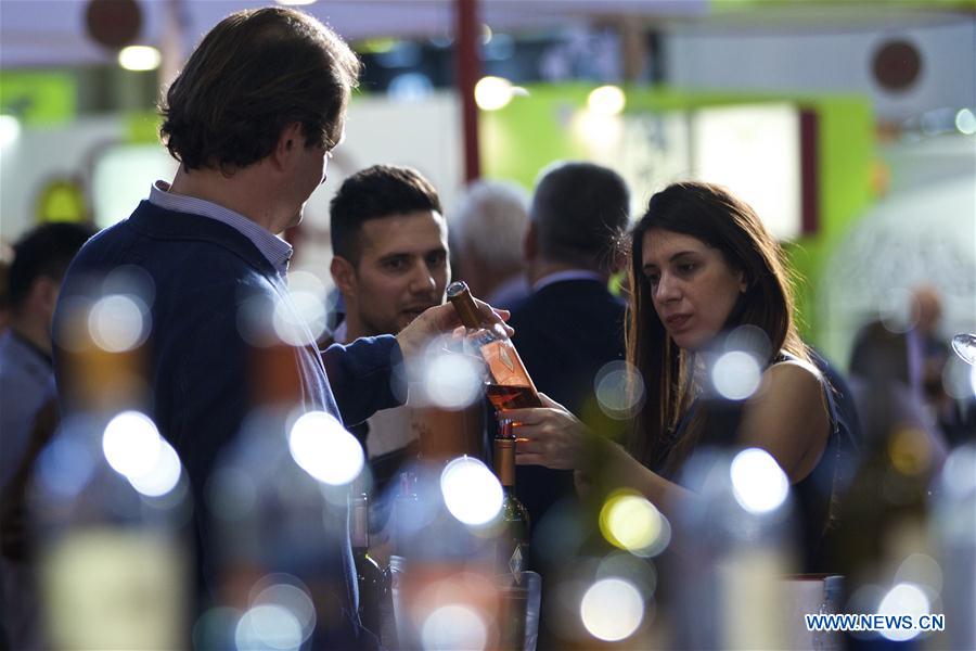 A visitor tastes the wine at Italy's Lombardy hall during Vinitaly in Verona, Italy, on April 11, 2016. Vinitaly 2016, the 50th edition of this international wine fair, began Sunday and will run until Wednesday, April 13. 