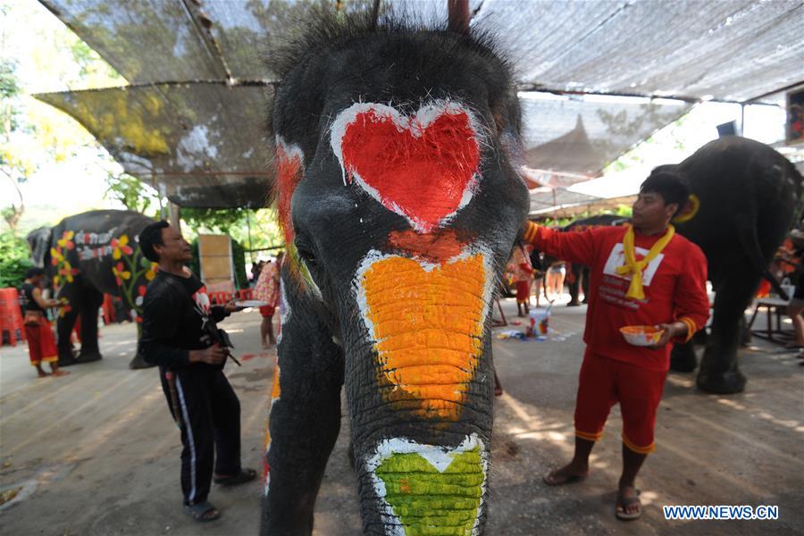 Workers paint on an elephant during the celebration for the upcoming Songkran festival in Ayutthaya province, Thailand, April 11, 2016.