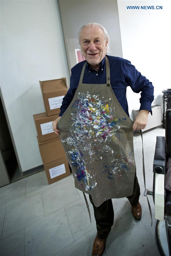 Mariani puts on his apron and gets ready to work in Milan, Italy, on April 13, 2016. 