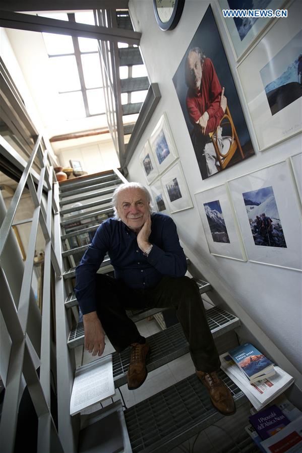 Photo takan on April 13, 2016 shows the artist Mariani, sitting on the stairs between his bedroom and studio in Milan, Italy.