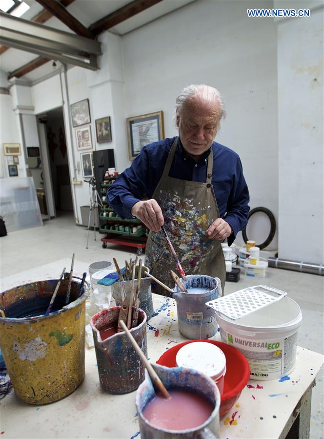 Mariani prepares to paint the fold made of lead sheet at his studio in Milan, Italy, on April 13, 2016.