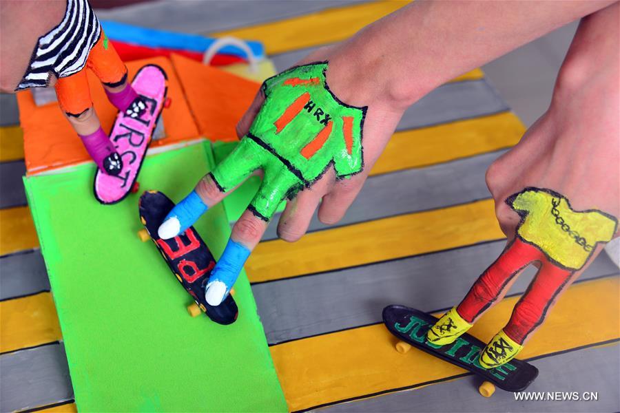 Students take part in a finger skateboard match at the School of Physical Education of the Liaocheng University in Liaocheng City, east China's Shandong Province, April 28, 2016