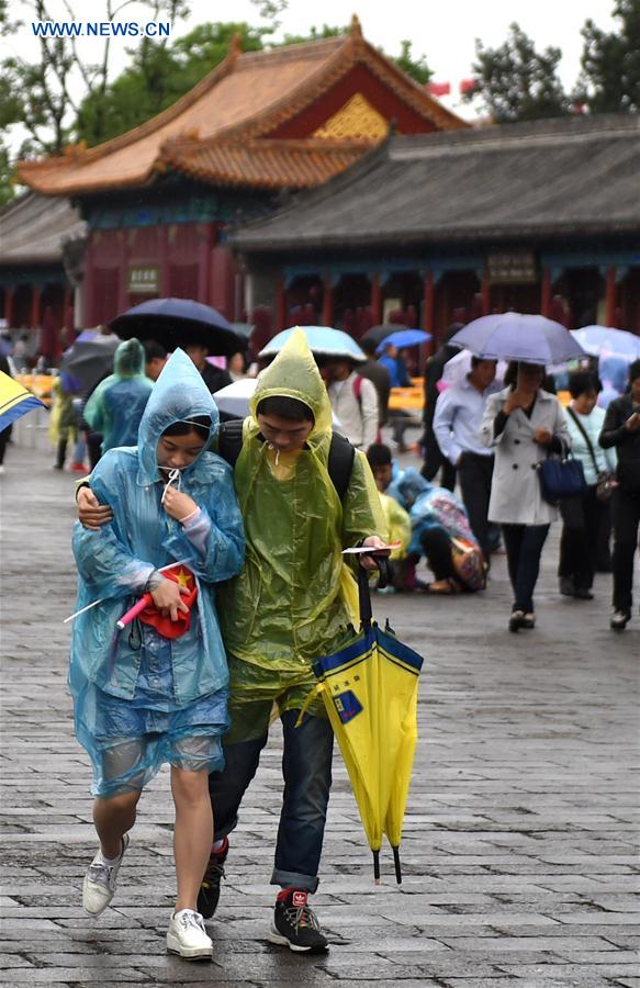 Tourists visit the Palace Museum on a rainy day in Beijing, capital of China, May 2, 2016.