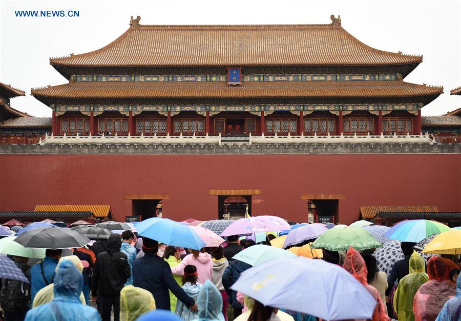 Tourists visit the Palace Museum on a rainy day in Beijing, capital of China, May 2, 2016.