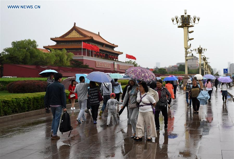 Tourists visit the Tian'anmen Square on a rainy day in Beijing, capital of China, May 2, 2016.