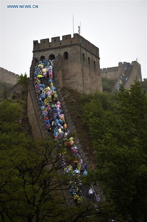 Tourists visit the Badaling Great Wall on a rainy day in Beijing, capital of China, May 2, 2016.