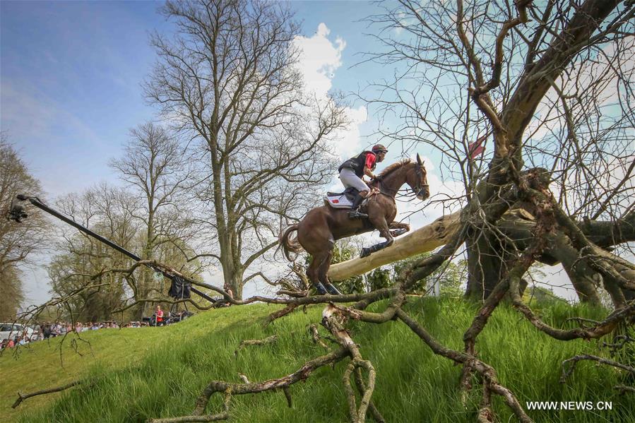 Chinese rider Alex Hua Tian with his horse 'Harbour Pilot C' jumps through the fence in Cross-Country Course at 2016 Badminton Horse Trials in Badminton, England on May 7, 2016.