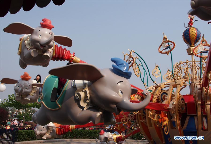 Visitors ride the Dumbo the Flying Elephant in the Disney Resort in Shanghai, east China, May 11, 2016.