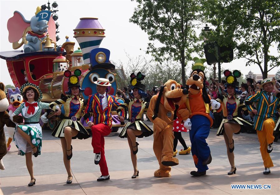 People dressed as Disney cartoon figures attend a parade in the Disney Resort in Shanghai, east China, May 11, 2016. 