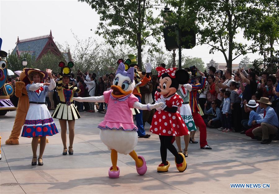 People dressed as Disney cartoon figures attend a parade in the Disney Resort in Shanghai, east China, May 11, 2016. 