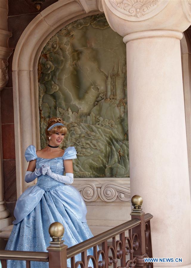 Photo taken on May 11, 2016 shows a woman dressed as a princess in the Enchanted Storybook Castle of the Disney Resort in Shanghai, east China. 