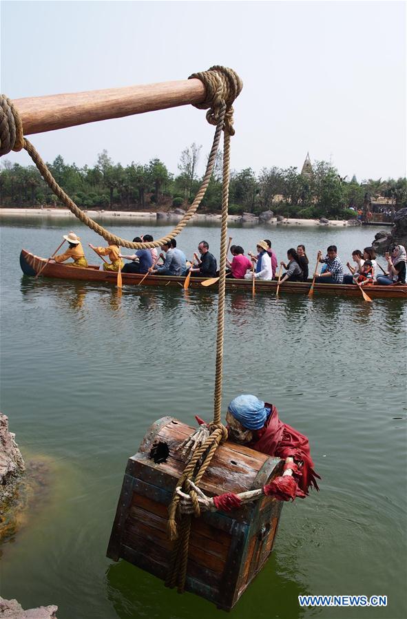 Visitors take a boat in the Treasure Cove of the Disney Resort in Shanghai, east China, May 11, 2016. 