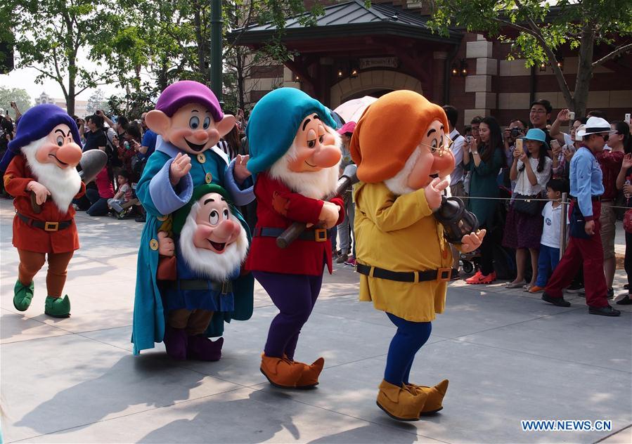 People dressed as dwarfs attend a parade in the Disney Resort in Shanghai, east China, May 11, 2016. 