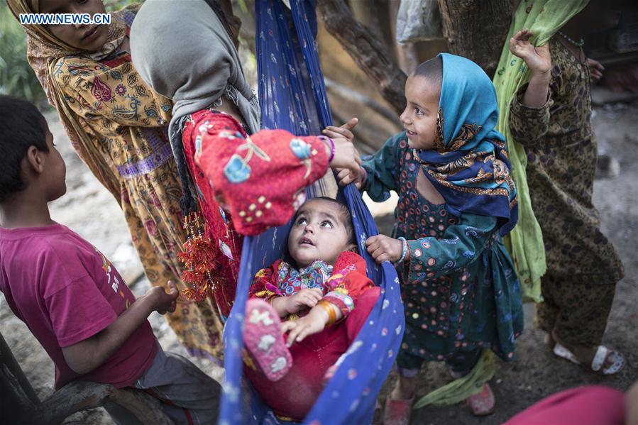 Pakistani refugee children play in a slum on the outskirts of Tehran, capital of Iran, on May 12, 2016.