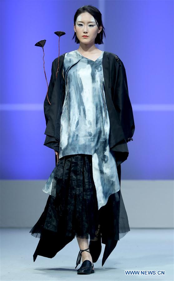 A model shows a creation of graduates from the Southwest University during the China Graduate Fashion Week in Beijing, capital of China, May 17, 2016.