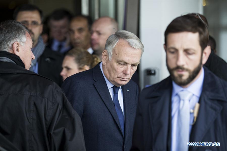 French Foreign Minister Jean-Marc Ayrault (C) leaves the Mercure Hotel next to the Roissy Charles de Gaulle Airport, where relatives of those on the missing plane gather, in Paris, France, May 19, 2016.