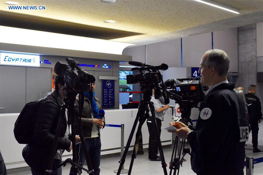 A policeman registers reporters at the counter of EgyptAir in Paris Charles de Gaulle Airport, France, May 19, 2016. 