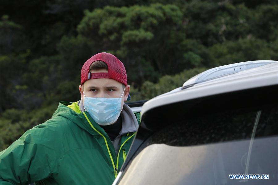  Two man look at a column of ash, emanating from the crater of the Turrialba Volcano, from the top of the Irazu Volcano, 65km southeast of San Jose, capital of Costa Rica, on May 21, 2016. 