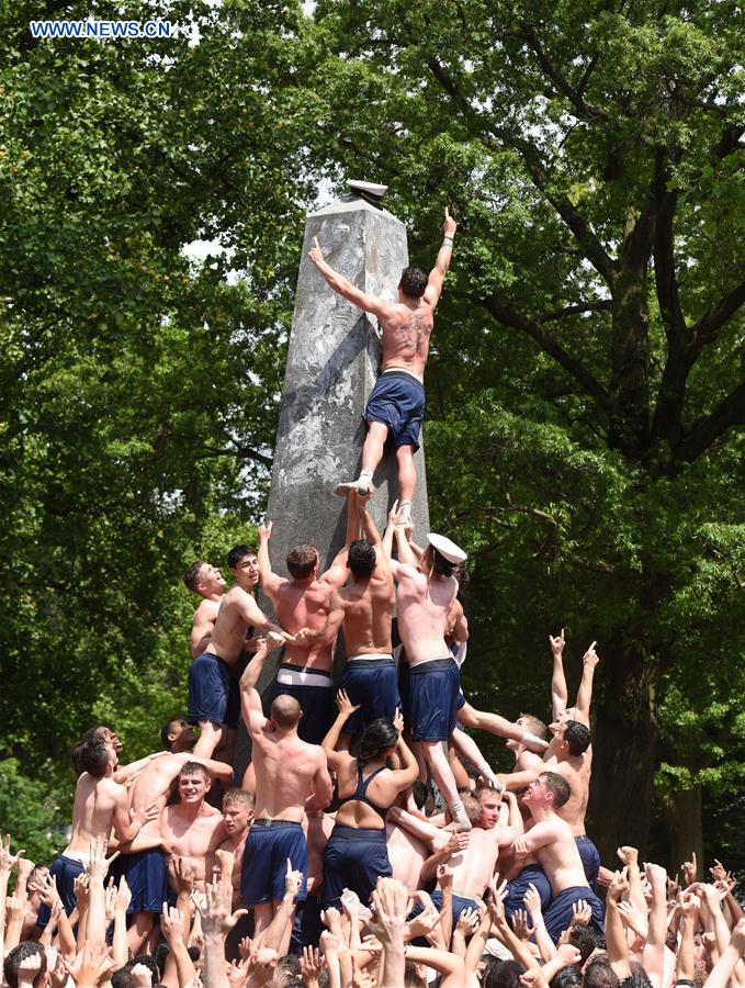 Plebes make a human wall to climb the Herndon Monument which is covered with vegetable shortening, at the U.S. Naval Academy (USNA) in Annapolis, Maryland, the United States, May 23, 2016. 