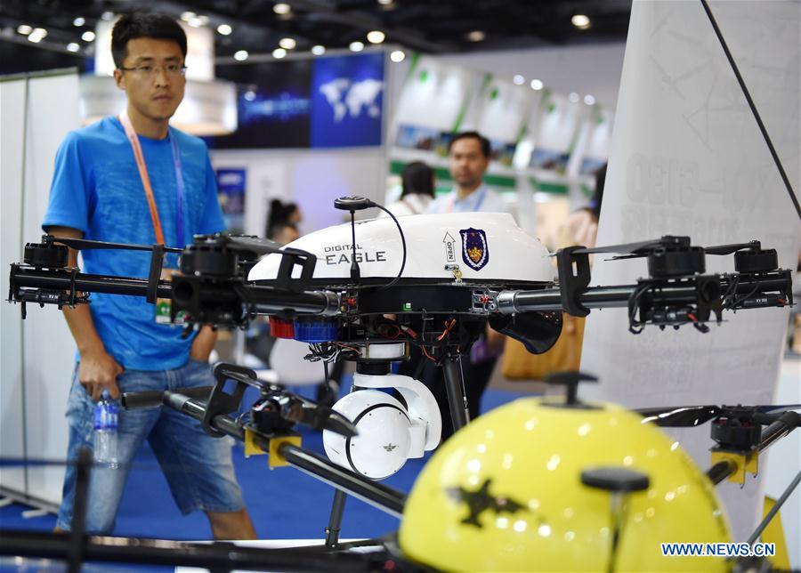 A man looks at a police unmanned aerial vehicle at the fourth China Beijing International Fair for Trade in Services in Beijing, capital of China, May 30, 2016.