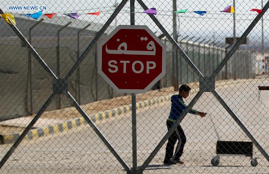 A Syrian refugee walks at the Mrajeeb Al Fhood refugee camp, east of the city of Zarqa, Jordan, May 31, 2016.
