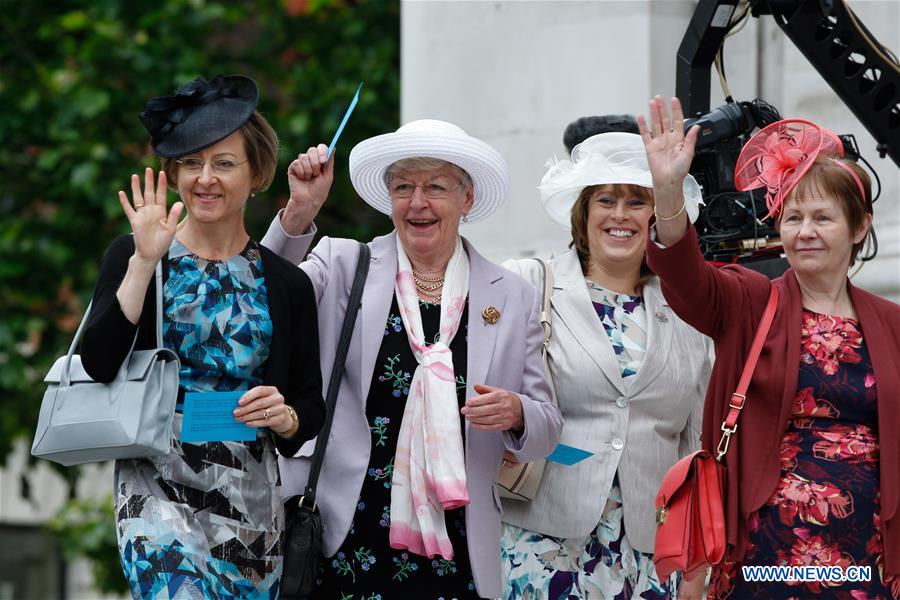 People wait for the arrival of Britain's Queen Elizabeth II outside the St. Paul's Cathedral for the National Service of Thanksgiving to mark the Queen's 90th birthday on June 10, 2016, in London, Britain. 