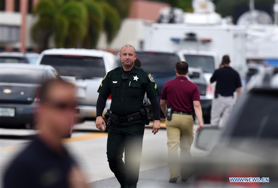 Highway-patrol troopers stand guard near the mass shooting scene in Orlando, the United States, June 12, 2016.