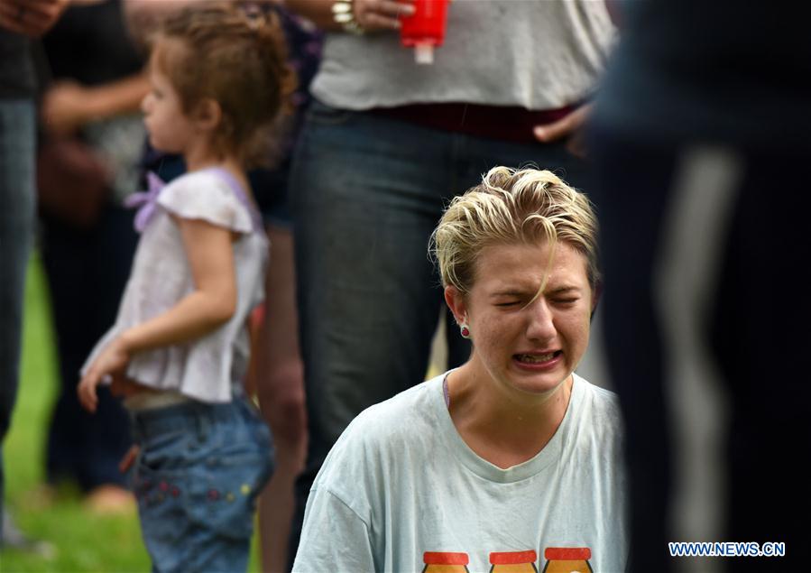 People mourn the victims of the mass shooting during a vigil at a park in Orlando, the United States, on June 12, 2016.