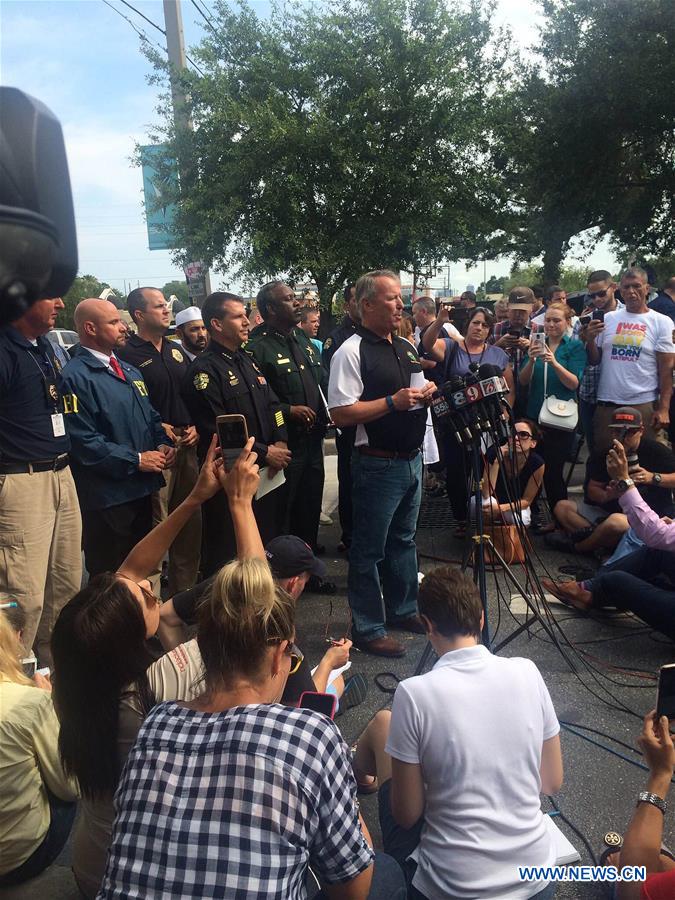 Highway-patrol troopers stand guard near the mass shooting scene in Orlando, the United States, June 12, 2016.