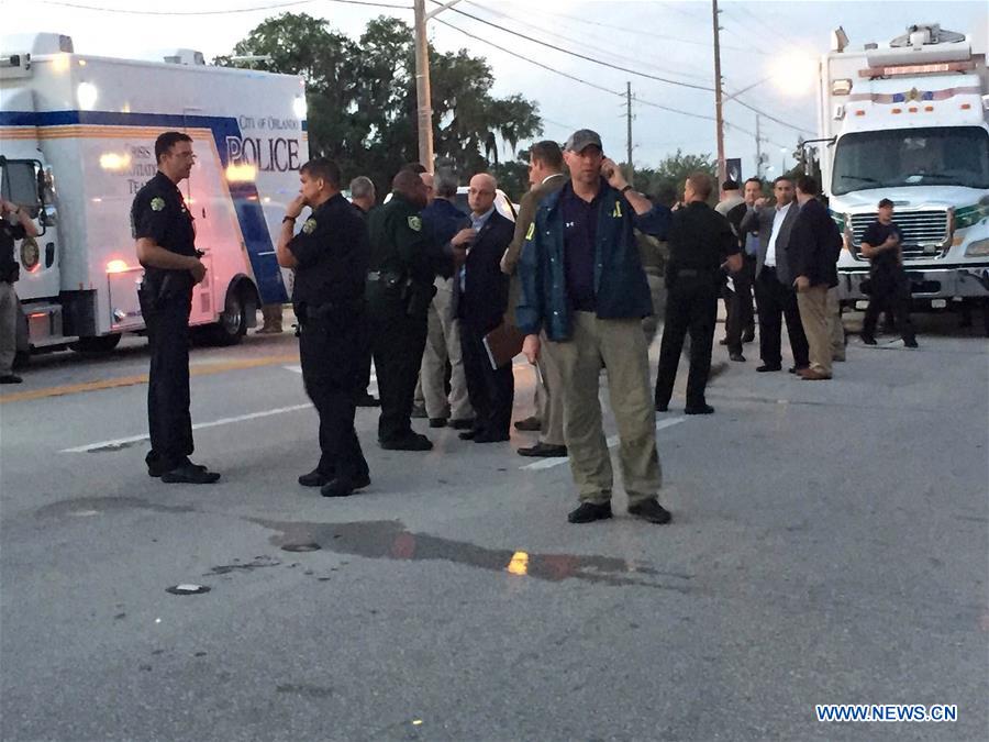Highway-patrol troopers stand guard near the mass shooting scene in Orlando, the United States, June 12, 2016.