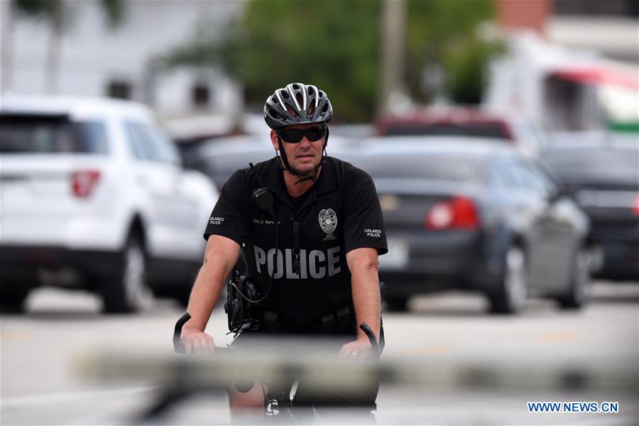 Highway-patrol troopers stand guard near the mass shooting scene in Orlando, the United States, June 12, 2016.