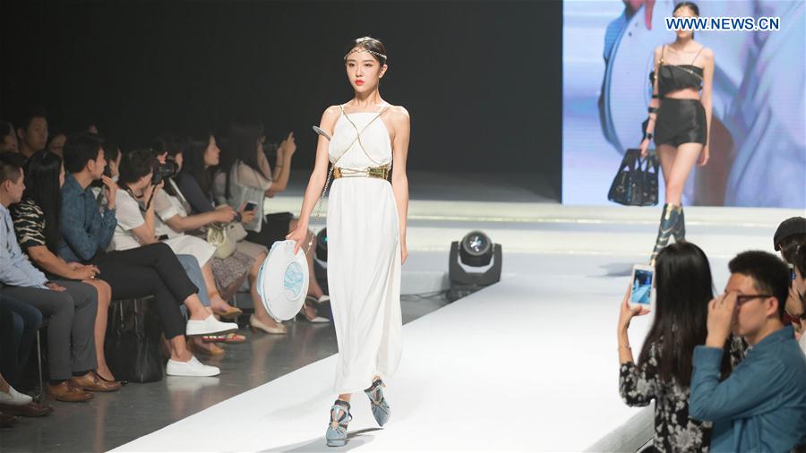 A model presents a creation designed by graduates of Beijing Institute of Fashion Technology in Beijing, capital of China, June 14, 2016.