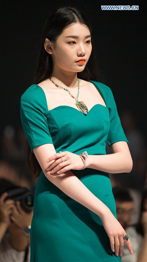 A model presents a creation designed by graduates of Beijing Institute of Fashion Technology in Beijing, capital of China, June 14, 2016.