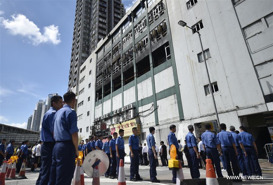 A memorial service is held at the fire site of an industrial building in Hong Kong's East Kowloon to pay tribute to Thomas Cheung, a 30-year-old senior station officer who died while battling the fire, in south China's Hong Kong, June 27, 2016. 