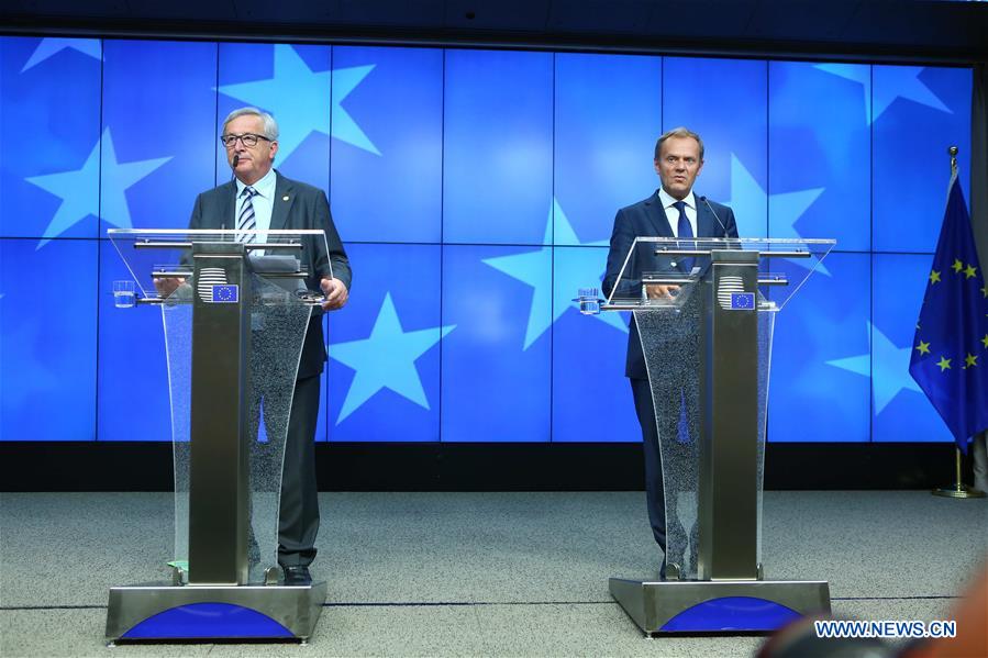 European Council President Donald Tusk (C) and European Commission President Jean-Claude Juncker (L) attend a press conference at the EU headquarters in Brussels, Belgium, June 29, 2016. 