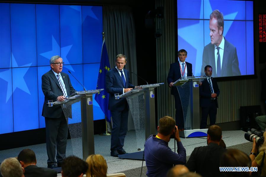 European Council President Donald Tusk (C) and European Commission President Jean-Claude Juncker (L) attend a press conference at the EU headquarters in Brussels, Belgium, June 29, 2016. 