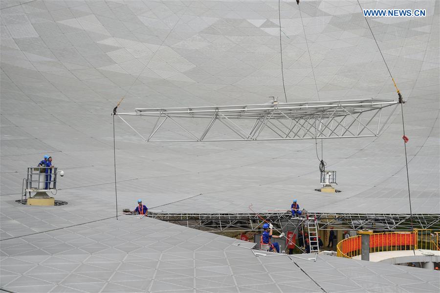 The last triangular panel to the reflector of the Five-hundred-meter Aperture Spherical Telescope (FAST) is being installed in Pingtang County, southwest China's Guizhou Province, July 3, 2016.