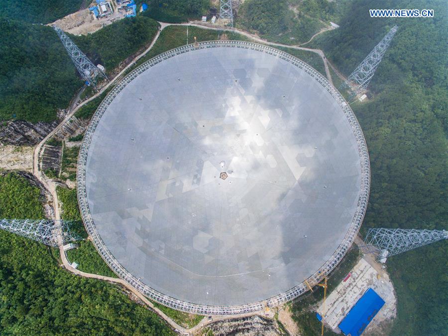 The aerial photo taken on July 3, 2016 shows the Five-hundred-meter Aperture Spherical Telescope (FAST) in Pingtang County, southwest China's Guizhou Province. Installation was completed on the world's largest radio telescope on Sunday morning as the last of 4,450 panels was fitted into the center of the big dish. 