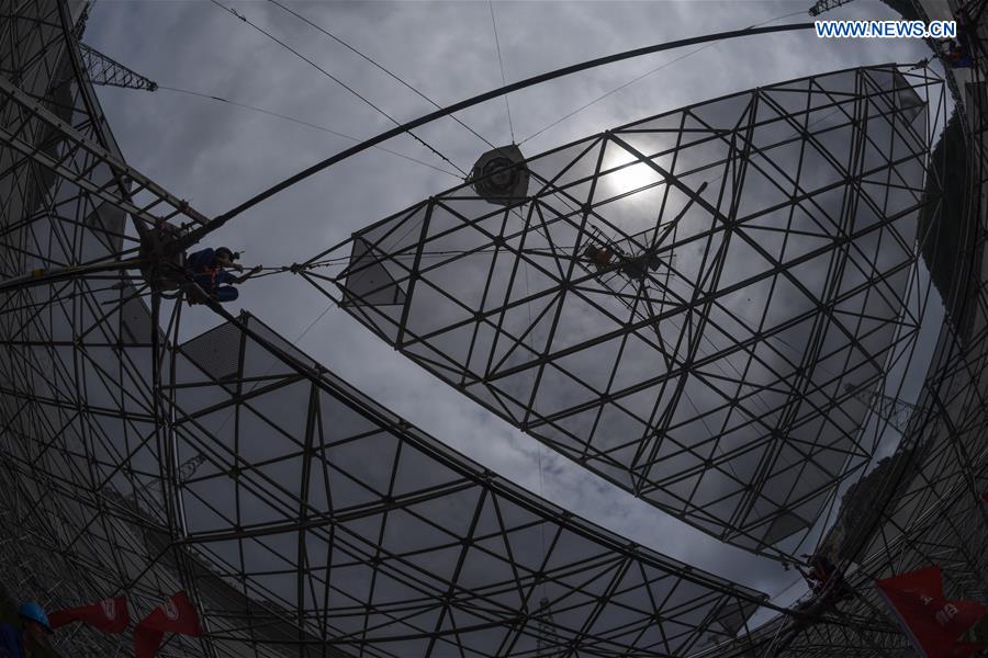 The last triangular panel to the reflector of the Five-hundred-meter Aperture Spherical Telescope (FAST) is being installed in Pingtang County, southwest China's Guizhou Province, July 3, 2016.