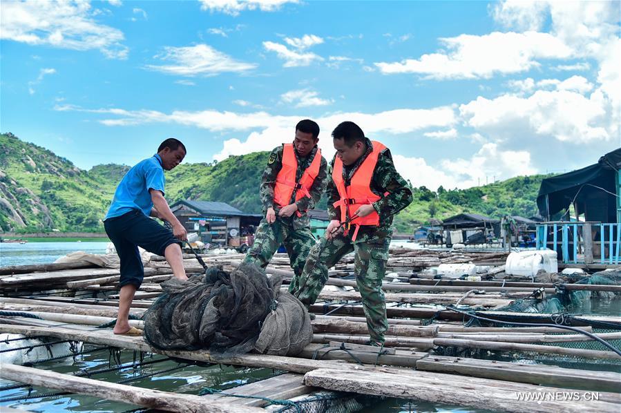 Frontier soldiers help a fisher pull a boat in Nanmenwu Village of Feiluan Township in Jiaocheng District of Ningde, southeast China's Fujian Province, July 7, 2016, before the upcoming Nepartak, the first typhoon of the year.