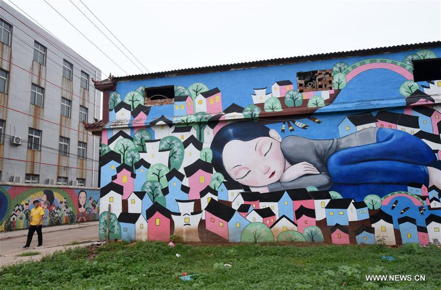 This year, local government decorated the Qiannanbu village with cultural graffiti works to improve the scenery. 