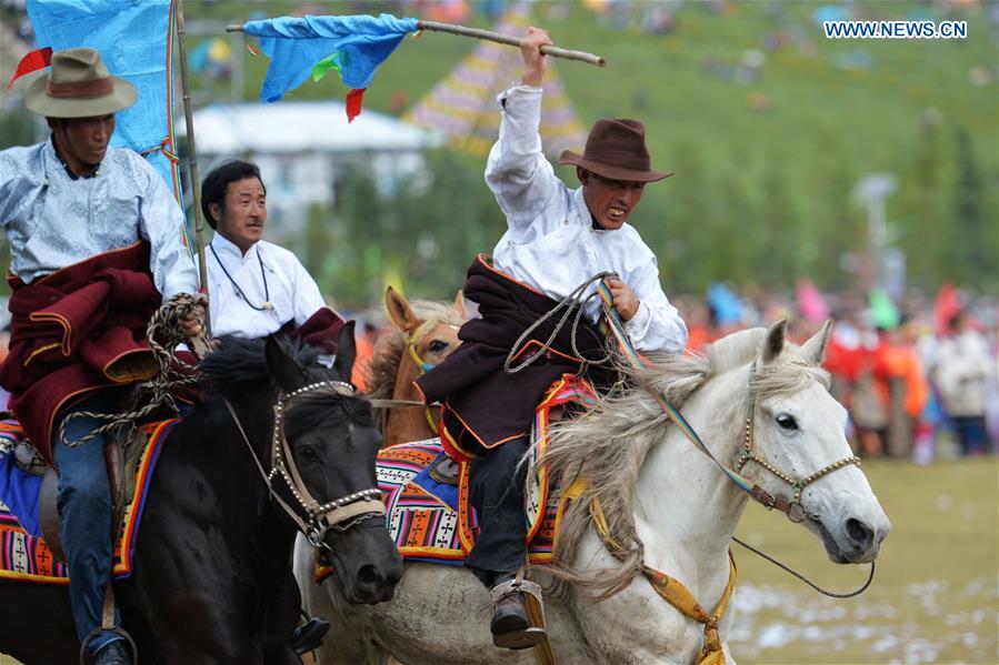 Riders perform the horse racing at the opening ceremony of Shambhala Tourism Festival in Gannan, northwest China's Gansu Province, July 17, 2016.