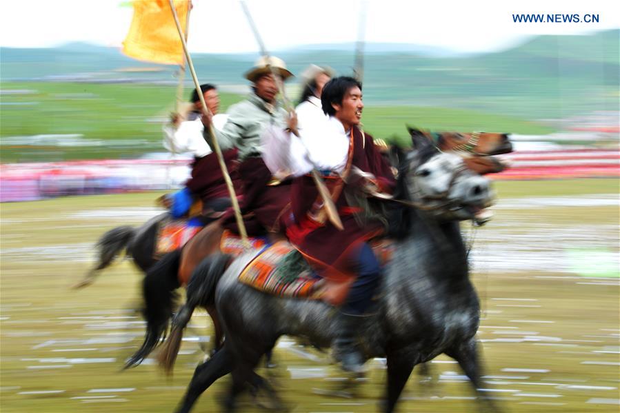 Riders perform the horse racing at the opening ceremony of Shambhala Tourism Festival in Gannan, northwest China's Gansu Province, July 17, 2016. 
