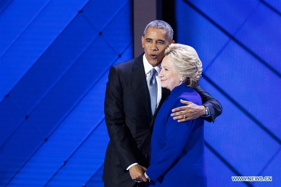 U.S. President Barack Obama (L) hugs U.S. Democratic Presidential Candidate Hillary Clinton on the third day of the 2016 U.S. Democratic National Convention, at Wells Fargo Center in Philadelphia, Pennsylvania, the United States, on July 27, 2016. 