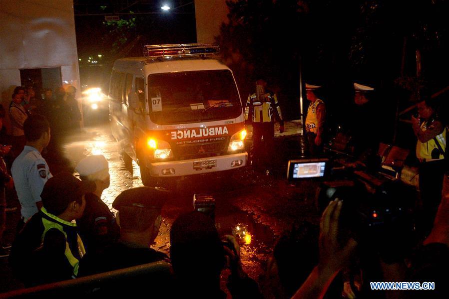 Police officers stand guard when an ambulance (not in frame) carrying the body of an executed prisoner leaves the port of Nusa Kambangan prison island in Cilacap, Central Java, Indonesia on July 29, 2016. 