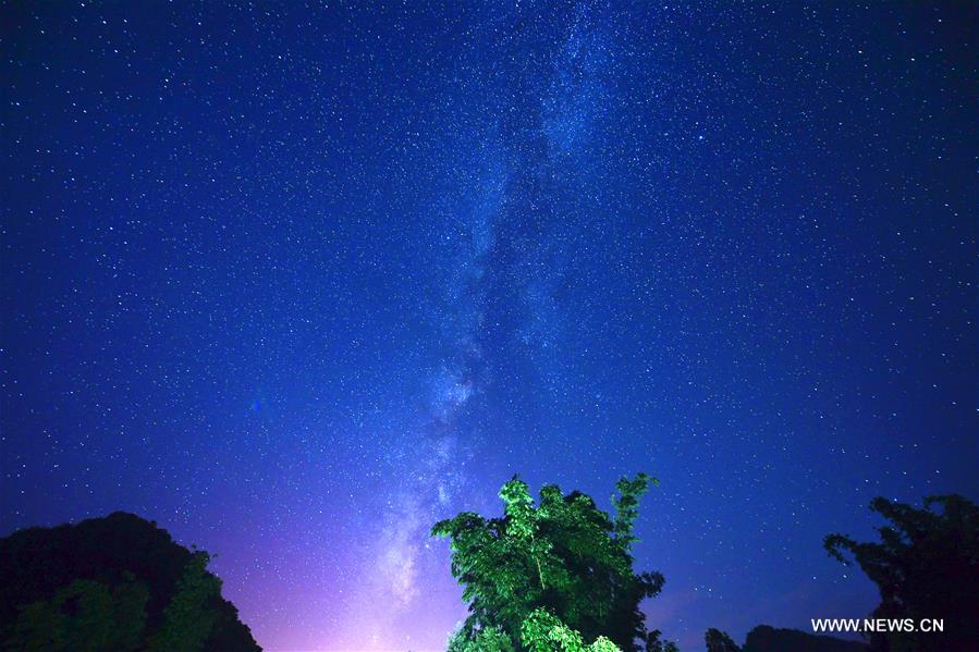 Photo taken on Aug. 25, 2016 shows starry sky in Jiulong Waterfall Scenic Spot of Luoping, southwest China's Yunnan Province.