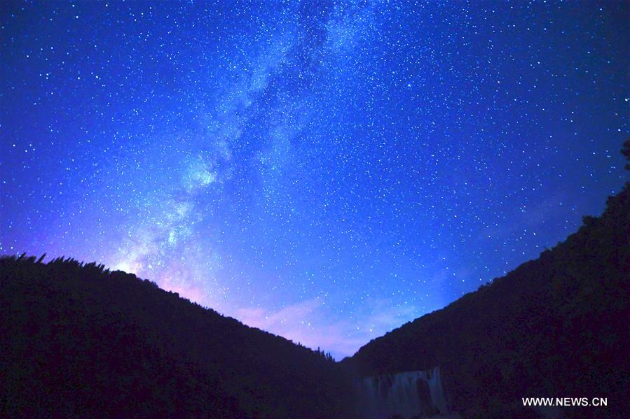 Photo taken on Aug. 25, 2016 shows starry sky in Jiulong Waterfall Scenic Spot of Luoping, southwest China's Yunnan Province.