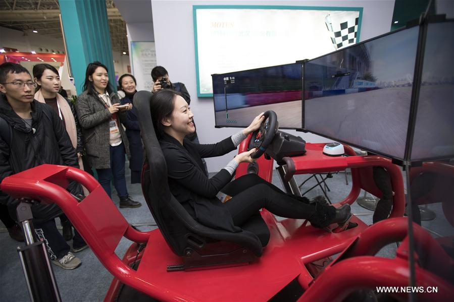 Visitors view a robot at the 13th Optics Valley of China International Optoelectronic Exposition and Forum in Wuhan, capital of central China's Hubei Province, Nov. 3, 2016.